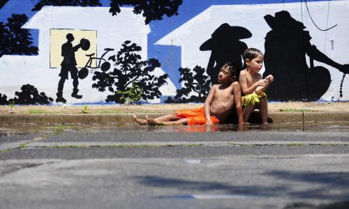 Two kids on a sidewalk