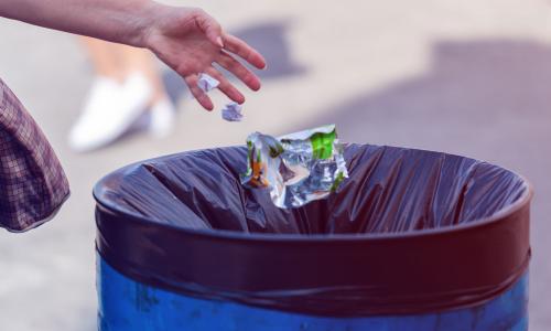 throwing a piece of trash in the garbage